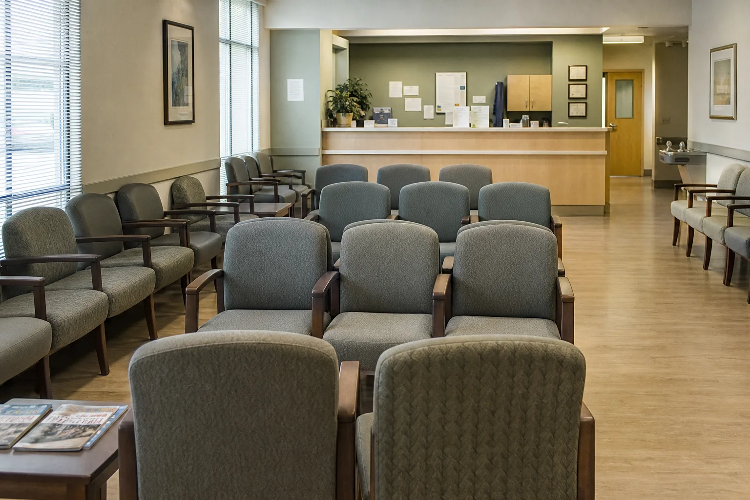 Clinic waiting-room chairs facing a reception counter